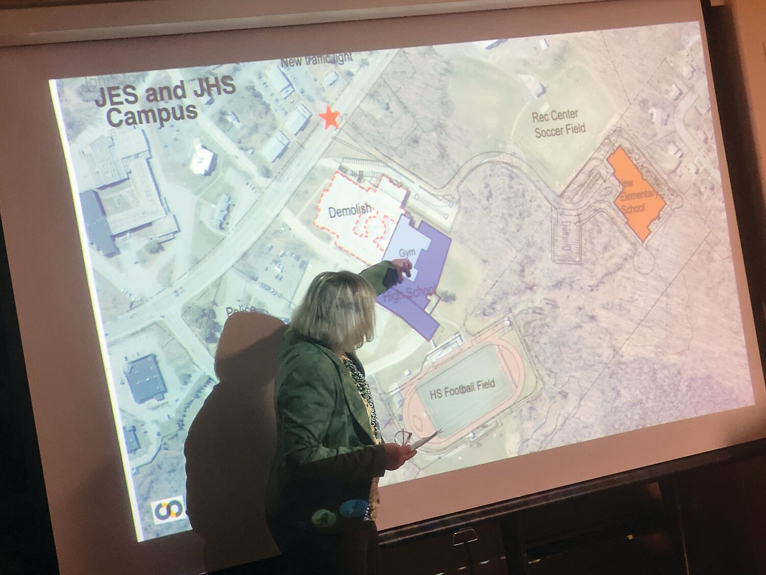 NEW JHS: Cathie Ellithorpe, Principal of the SLAM Collaborative, unveils the earliest plans of a planned new Johnston High School. Note the portion of the existing high school to be demolished in red, and the newly built structure in blue.